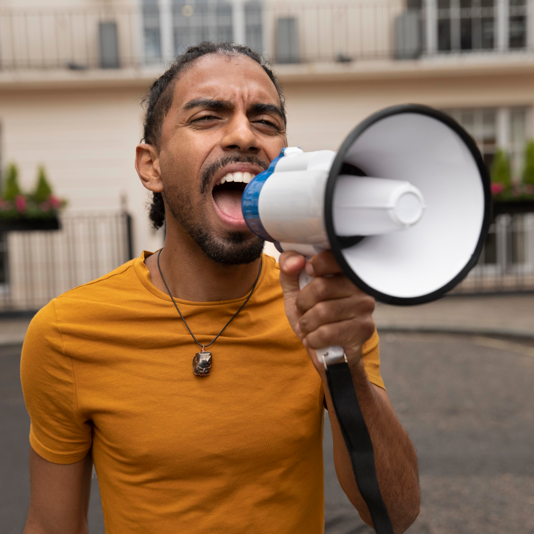 Gentleman with megaphone yelling at QS Fidelis Maiba